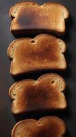 A detailed view of toast, lightly burnt and crispy, with rich, textured brown crust. photo