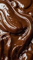 A detailed macro photograph of melted chocolate, highlighting its glossy finish and soft, swirling patterns. photo