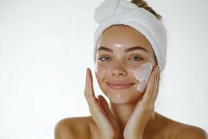 A woman with a towel on her head and a face mask photo