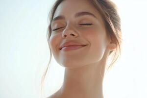 Beautiful young woman with closed eyes and smiling photo