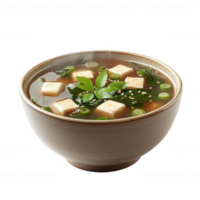 A bowl of soup with tofu and greens in it png