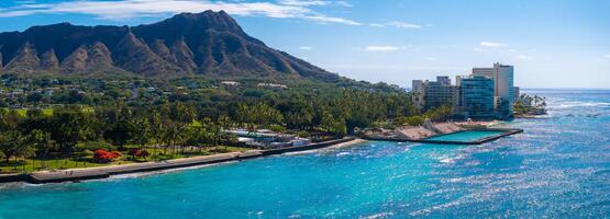 Aerial view of Waikiki Beach in Honolulu, Oahu, Hawaii, featuring Diamond Head Crater, turquoise waters, palm trees, and modern oceanfront buildings. photo
