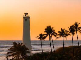 Sunset View of a White Lighthouse with Palm Trees in Oahu, Hawaii photo