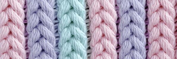 Multicolored yarn knit close-up texture with pastel shades for textile design photo