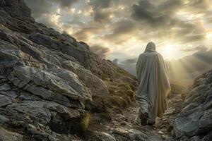 A man in a robe walks up a rocky path photo