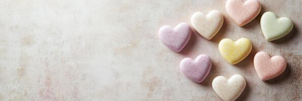 Heart-shaped pastel macarons on rustic background for sweet dessert concept photo