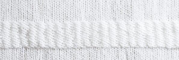 Close-up of white knitted fabric texture with horizontal ribbing pattern photo