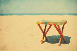 Colorful wooden table on a sandy beach under clear blue sky and horizon in vintage or retro postcard style photo