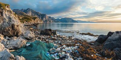 Coastal pollution with plastic waste on rocky mediterranean shoreline at sunset photo