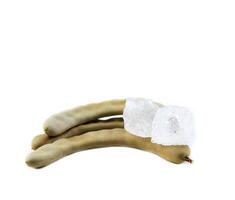8. A chunk of alum is placed atop a ripe sour tamarind on a white background. This composition highlights the significance of natural elements in traditional medicine, cleansing, and food preparation. photo