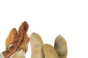 2. Cutout sour tamarind on white background. The variety with a sour taste comes from tartaric acid. Fresh pods are used in cooking to add sourness, mature pods are used to make tamarind paste. photo