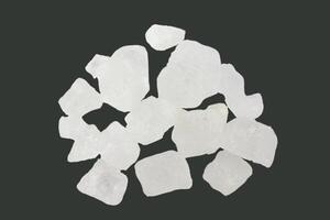 7. Pieces of alum stone on dark background. Concept of the connection between medication ingredients in traditional practices and holistic wellness. photo