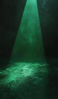 Emerald spotlight illuminates textured surface in dim room with murky atmosphere glow photo