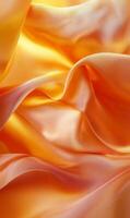 Radiant tangerine silk cascades in soft undulating waves with luminous highlights shimmering photo