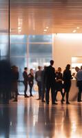 Blurred motion of people in a modern office building reflecting on the floor photo