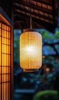 Illuminated woven lantern casts a warm inviting glow on a peaceful oriental setting scene photo