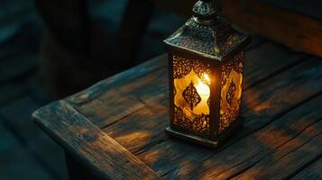 Ornate lantern glows warmly, illuminating aged wooden surface with intricate patterns of light photo