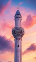 Minaret soaring towards a vibrant sunset sky, architecture meets celestial beauty and soft light photo