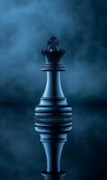 Intricate Chess King Piece Emerging from Enigmatic Dark Blue Mist on Reflective Surface photo