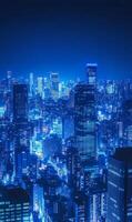 Electric blue cityscape at night with towering structures and glimmering illumination display photo