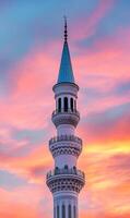 Minaret silhouette at dusk with beautiful sunset creating tranquil religious scenery photo