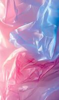 Translucent fabric draped in soft pinks and blues casting an ethereal glow and texture photo
