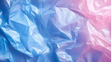 Translucent texture in gradient shades of blue and pink forming rippled, abstract patterns photo