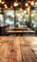 Rustic wooden table surface in a warmly lit cafe interior with blurred lights background photo
