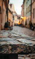 Charming cobblestone street view in a historical european city with blurred warm lights bokeh photo
