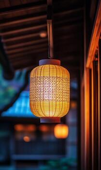 Glowing paper lantern softly illuminates Japanese architecture with warm light, invoking tranquility photo