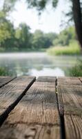 Tranquil misty morning view from a weathered wooden dock overlooking a serene lake scene photo