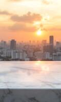 Marble surface showcases a golden sunset panorama of a blurred urban horizon tableau photo
