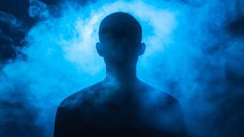 Mysterious silhouette enveloped in ethereal blue smoke, hinting at identity and intrigue photo