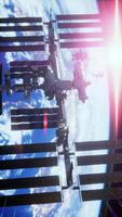 International Space Station orbits Earth under a bright sunlit sky video