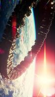 A futuristic spaceship orbits above Earth, illuminated by the suns rays video
