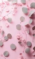 Delicate eucalyptus foliage arrangement on a pastel pink backdrop, soft botanical elegance photo