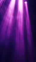 Ethereal purple light beams illuminating dark space creating a mystical atmosphere photo