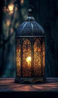 Ornate lantern glows softly on a wooden surface with a dreamy, blurred forest backdrop photo