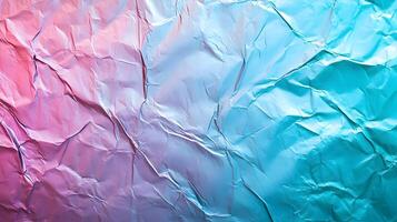 Iridescent crumpled foil texture with pink and cyan gradient creating a modern backdrop photo
