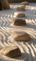 Tranquil zen garden arrangement featuring textured stones and raked sand patterns for serenity photo