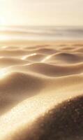 Golden hour kisses the tranquil beach sand creating small undulating waves near the ocean photo