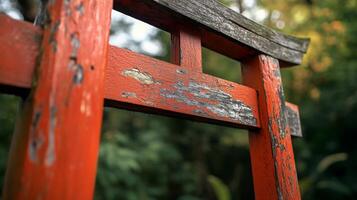 Ancient torii gate with aged paint and blurred background amidst lush vegetation in a park photo