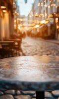 Empty table on a quaint european street with blurred lights illuminating the background beautifully photo