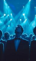 Formal event with crowd illuminated by blue lights focusing on an elegant attendee photo
