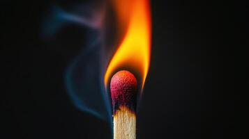 A matchstick with a flame burning on it photo