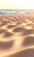 Golden hour illuminates sandy beach dunes with blurred ocean backdrop creating tranquility photo