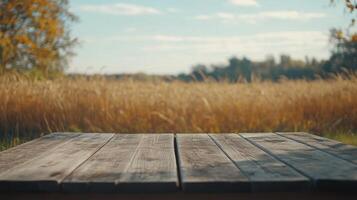 Rustic Wooden Tabletop Overlooking Golden Wheat Field Under a Sunny Sky Backdrop photo
