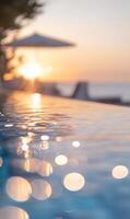 Tranquil infinity pool reflecting a vibrant sunset, creating a serene and inviting atmosphere photo