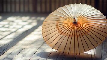 Elegance captured through a traditional japanese umbrella on aged wooden floor bathed in soft sun rays photo