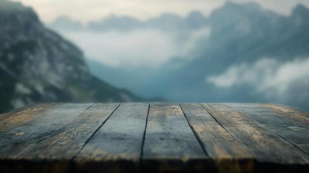 Rustic wooden table against a hazy mountain backdrop creates a sense of serene grandeur photo